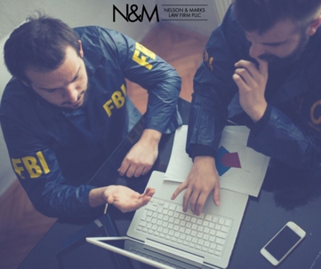 FBI agents look at a laptop