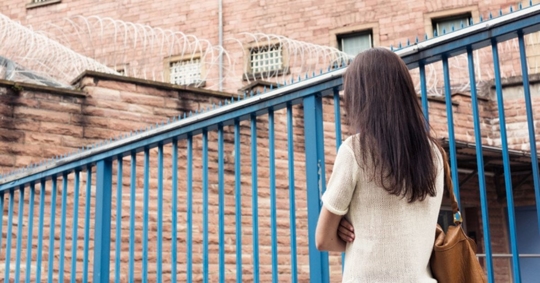woman standing outside jail